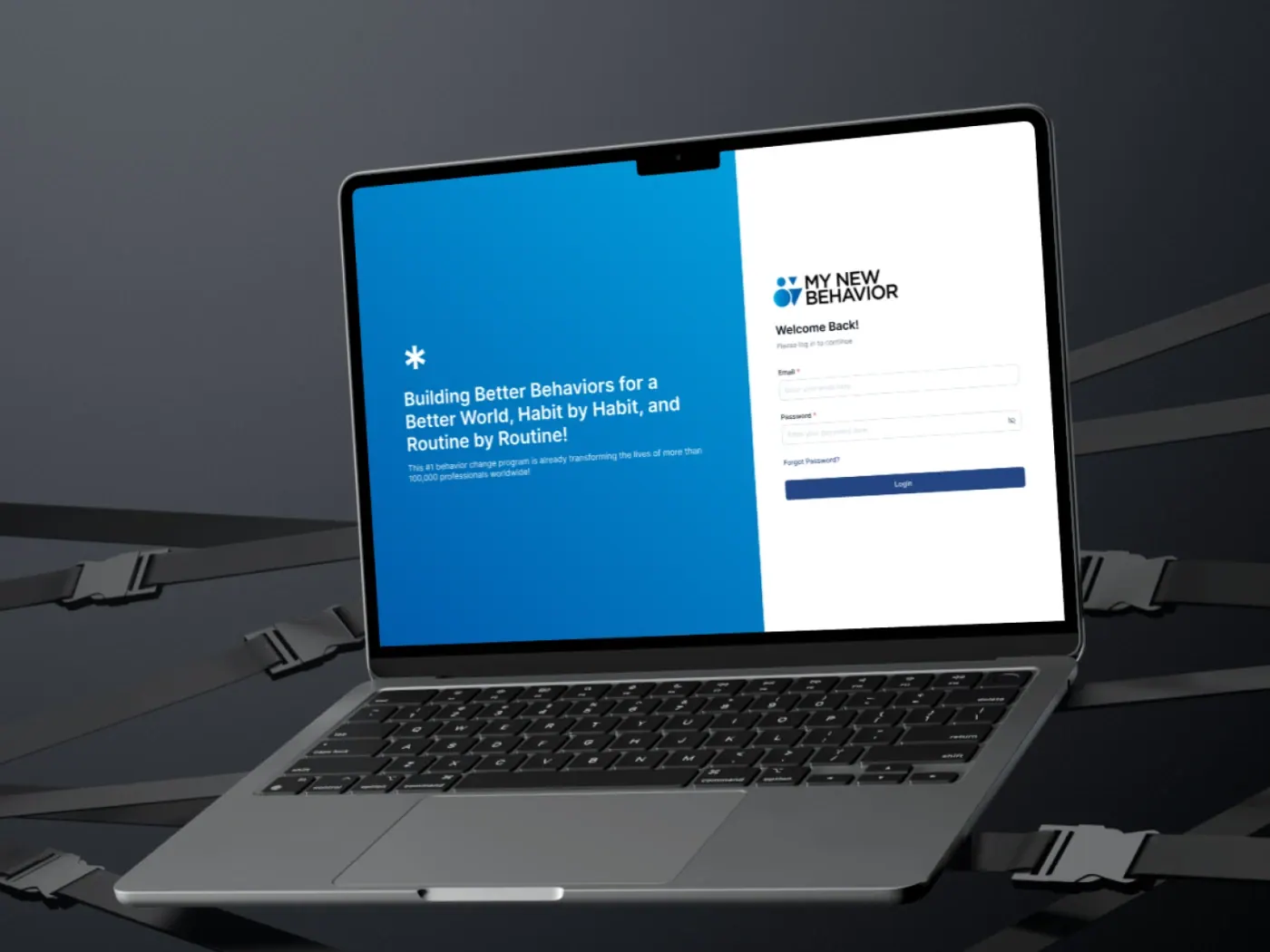 The My New Behavior web app open on a laptop, showing the sign-in screen beside the product’s welcome message